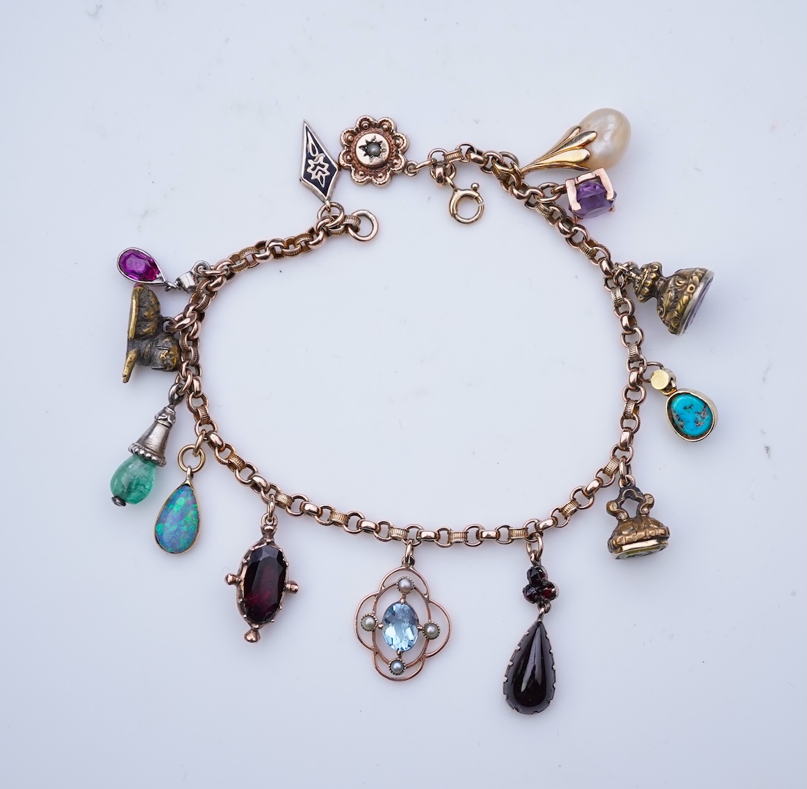 A gem-set charm bracelet, late 19th-early 20th century